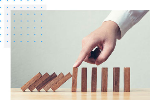 Finger stopping dominoes from falling