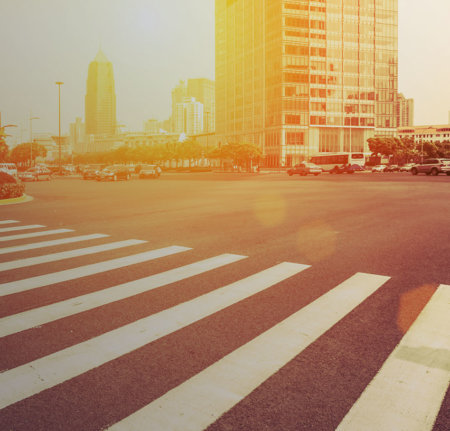 A city intersection with sunset in the distance