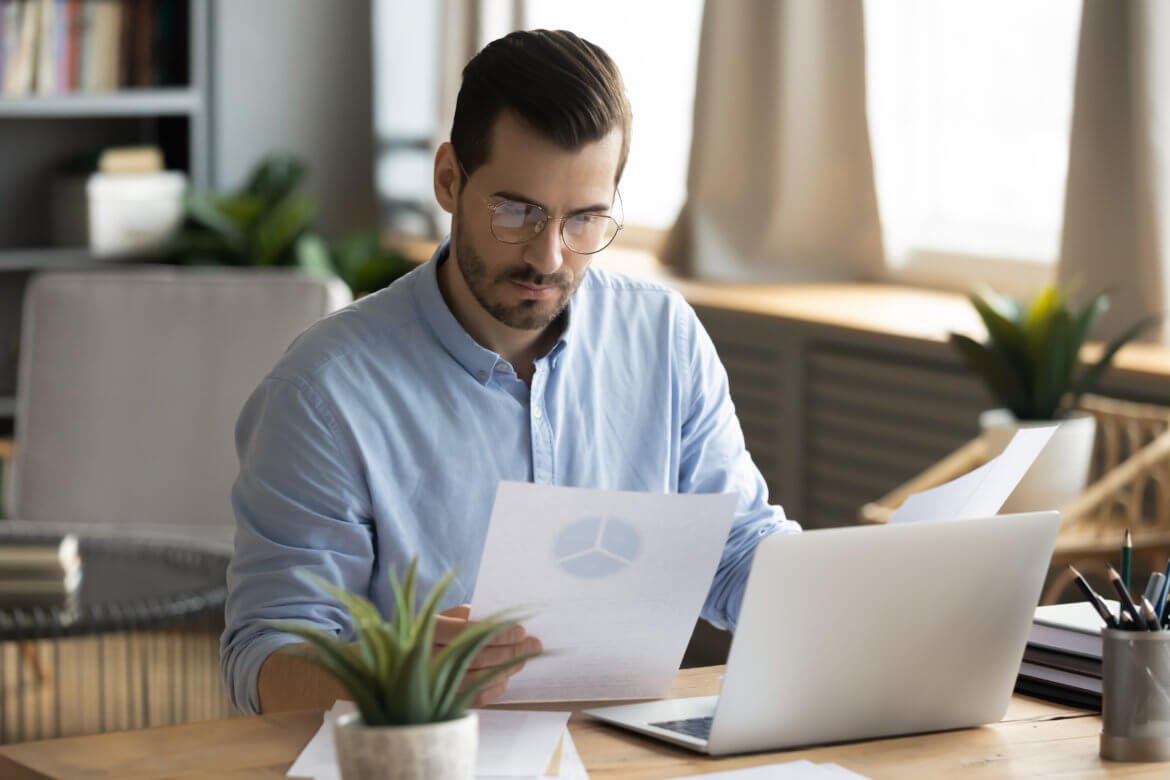 A man reviews financial data for a client's audit.