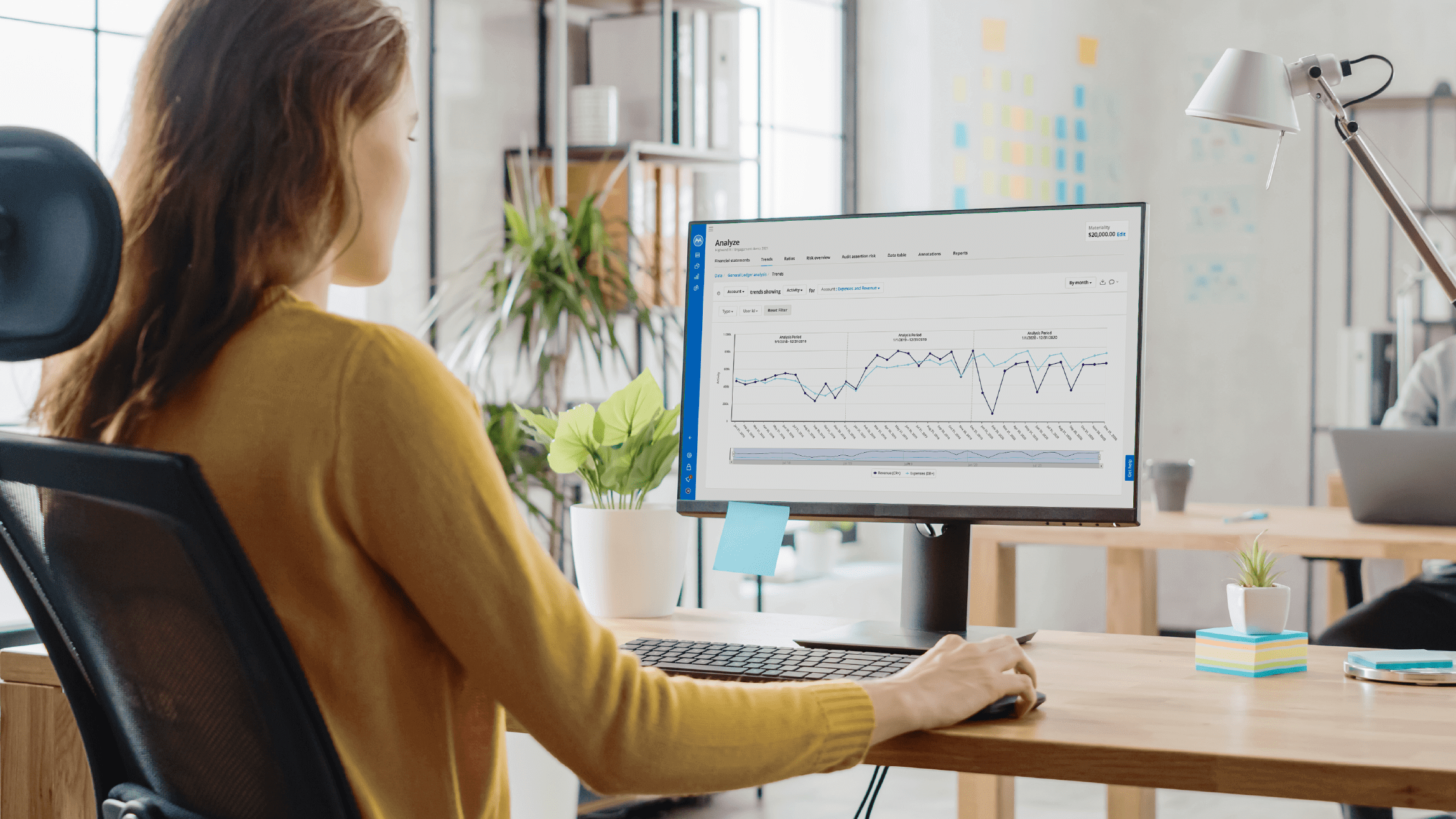 Businesswoman analyzing data on computer monitor